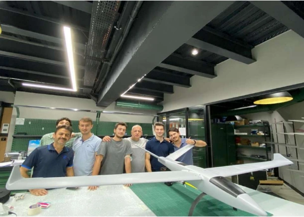 Research team working together around an unmanned aircraft prototype